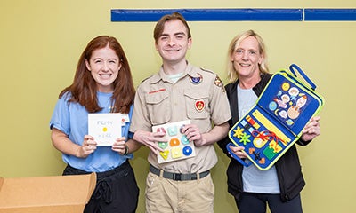 Rex Everette with Helen Hall (left) and Anna Ballenger (right) of the Children's of Alabama PT/OT team