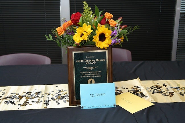Florals and plaque from Dr. Habeeb's retirement party.
