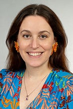 Laura L Stafman, MD, PhD, smiling in a bright blue shirt.